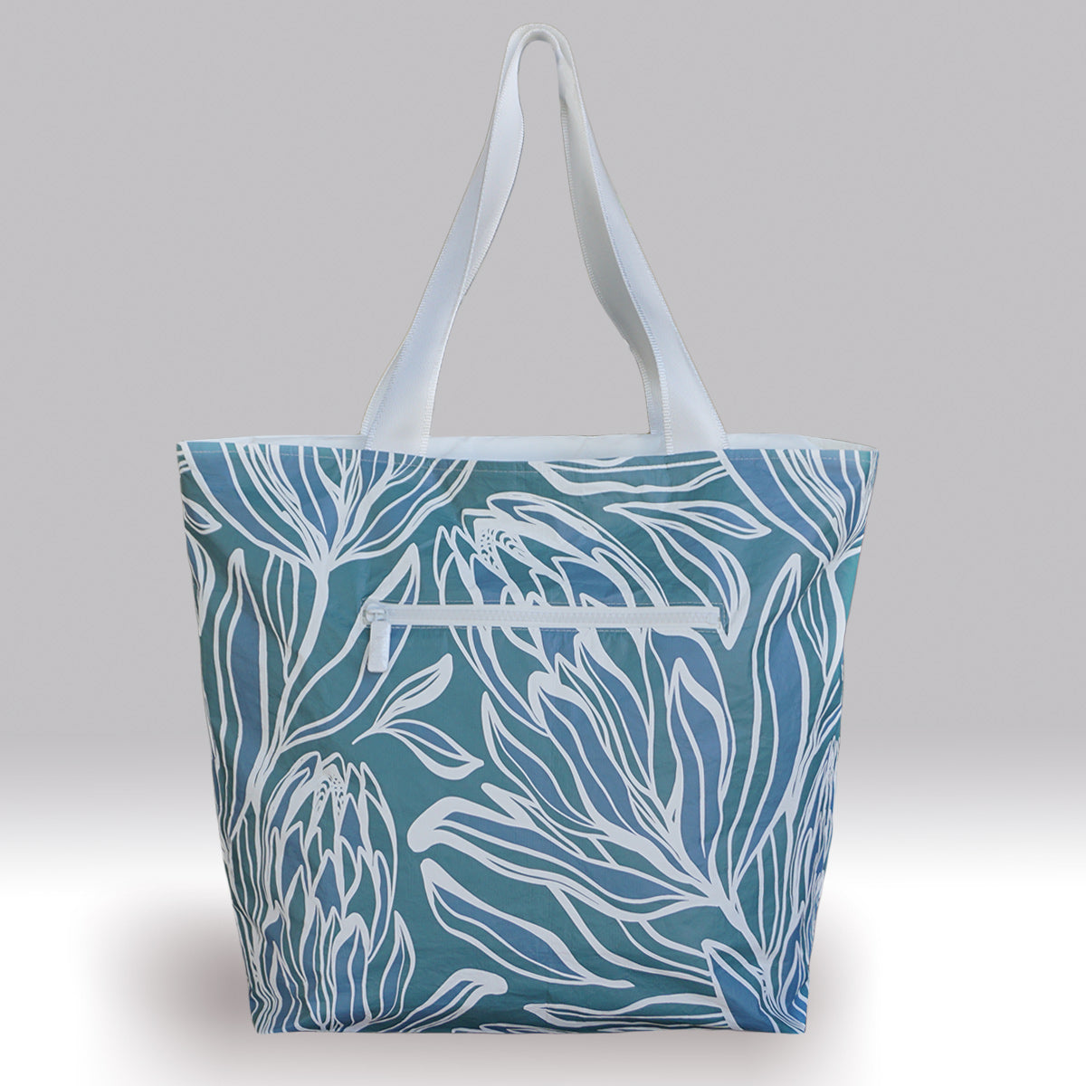 Large tote bag for the beach. Water proof with zipper enclosure and pockets. White bag with blue and stone gray color design.